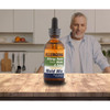 Man in a kitchen behind Allergena Mold Mix bottle on a counter