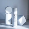 iS Clinical Brightening Complex bottle among white geometric shapes
