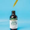 Dropper above the Baikal Skullcap bottle on a blue background
