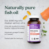 Wholemega bottle beside salmon fillet and rosemary, clinically studied omega oil