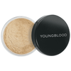 Open jar of dark Youngblood rice setting powder beside its black lid