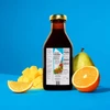 Floradix Calcium bottle with orange, pear and mango on a blue background