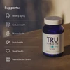 Tru Niagen bottle on a table with icons for aging, cells, muscle, brain and heart