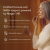 Woman taking a capsule, fortified immune and NAD+ support powered by Niagen NR
