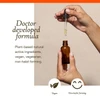 Hands holding a dropper over a bottle, doctor developed formula graphic