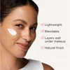 Woman with a dab of sunscreen on her cheek and four feature checks