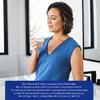 Woman drinking a glass of water above creatine mixing directions