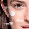 Woman with Hyalu B5 cream on her cheek showing the cream texture