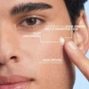 Man applying lotion to his cheek, fast absorbing, non-drying lotion texture callouts