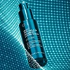 Multi Peptides GF Advanced Lifting Serum bottle on teal grid background