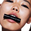 Model holding the lip balm in her mouth