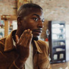 Bearded man touching jawline in mirror, Anti-Bump Treatment lifestyle