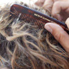 Hand styling wavy hair with Baxter tortoiseshell Pocket Comb