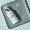 Even Up Multi Correction Serum bottle on a sage green tray