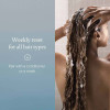 Woman lathering shampoo in her hair, weekly reset for all hair types
