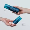 Hands holding full size 5 oz and travel size 1.7 oz Leave-In Conditioning Spray bottles