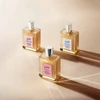 Three philosophy luminous body oil fragrance bottles lined up