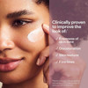 Woman applying Super-C Night cream to cheek, clinical benefits list