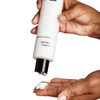 Hands dispensing PCA Skin Creamy Cleanser into palm