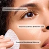 Woman wiping her cheek with a pad, ingredient benefit callouts