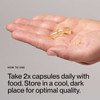 Hand holding three Vegan Omega-3 softgels, take 2 daily with food