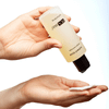 Hand pouring PCA Skin Nutrient Toner onto cotton pad