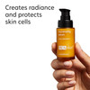 Hand holding PCA Skin Rejuvenating Serum bottle with radiance text