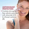 Smiling model applying EltaMD UV Daily to cheek with antioxidant protection text