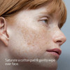 Freckled model in profile with cotton pad toner directions text