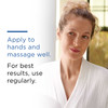 Woman with hair up beside directions to apply to hands and massage