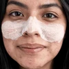 Woman wearing white foaming mask on her nose and cheeks