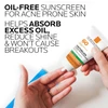 Hand holding Anthelios Clear Skin tube, oil-free sunscreen for acne-prone skin text