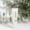 epionce Purifying Spot Gel tube standing in front of green leaves