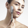 Woman using the ReFa I Style roller on her cheek