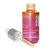 Open serum bottle with dropper lying beside it