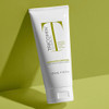 Tricomin conditioner tube on a green background