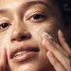 Woman massaging foamy cleanser onto her face