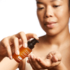 Woman dispensing Acne Gel into her palm