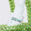 Dermalogica Micro-Pore Mist bottle surrounded by green beads