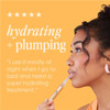 Woman applying GrandeLIPS gloss with hydrating + plumping quote