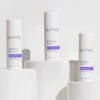 Three Glytone Exfoliating Serum bottles on white blocks