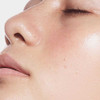Close-up of dewy skin on a model's nose and cheek