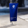 iS Clinical Cleansing Complex Polish tube on a poolside ledge