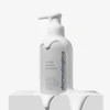 PreCleanse bottle on a white block with dripping cleanser