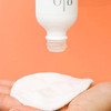 glo Hydra-Bright exfoliant being poured onto a cotton pad