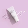 glo Soothing Gel Mask tube with gel swatches on a lilac background