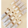 glo C-Shield Moisture Tint tubes in all shades scattered on beige