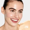 Smiling woman with light skin wearing C-Shield Moisture Tint shade 2N