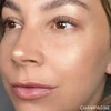 Model wearing Skin Glow Powder Highlighter in Champagne on the cheekbone