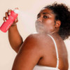 Woman spraying Bacne Spray onto her back